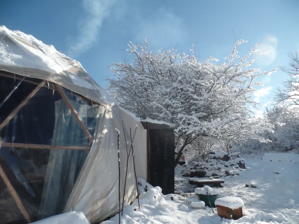 Wooden geodesic dome made by Domeciel under the snow